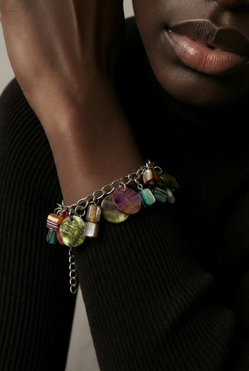 Accessory>Jewelry                                Bracelet w/ metallic charms.